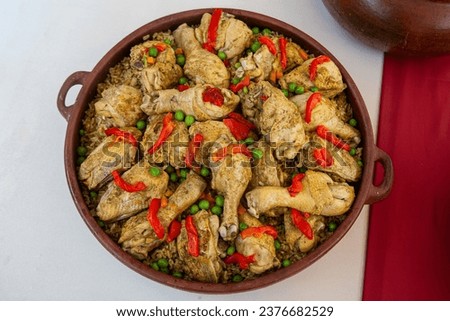 Peruvian Arroz con Pollo is a flavorful and comforting dish that combines chicken and rice with a delightful blend of spices and herbs. It's a popular Peruvian comfort food loved by many. Royalty-Free Stock Photo #2376682529