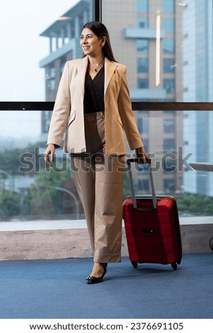 Smiling Flight Attendants with Suitcase in Airport 