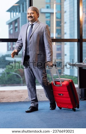 Photo of a senior businessman at an airport.