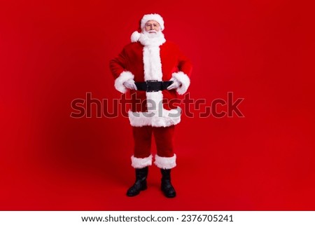 Full length photo of cheerful good mood santa claus winter magic season new year time isolated on red color background Royalty-Free Stock Photo #2376705241