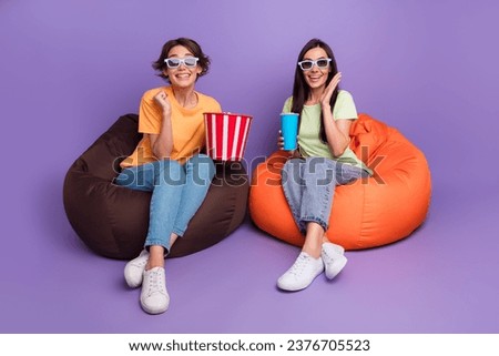 Full body length photo cadre of two delighted girls drink fizzy coke eat popcorn crazy cartoon 3d cinema isolated on violet color background