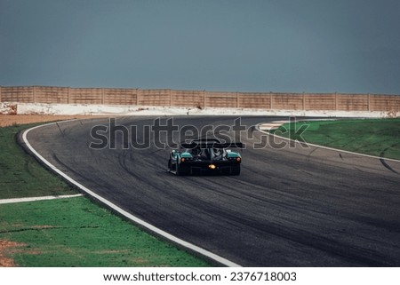 Sport racing prototype go fast at the race track fast with a after burn Royalty-Free Stock Photo #2376718003