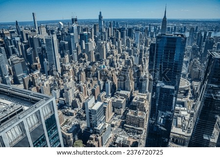 An aerial view of the rooftops of buildings and bustling streets of New York.