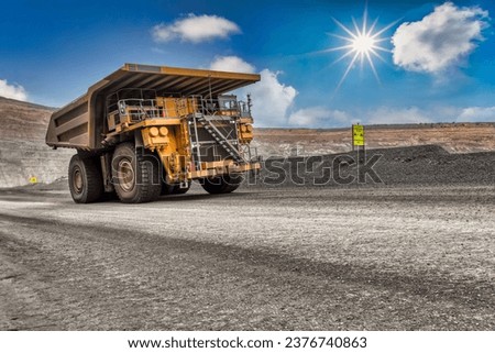 heavy truck , at the open pit diamond mine carry a kimberlite load uphill the dirt road Royalty-Free Stock Photo #2376740863