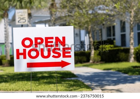 Open house sign with arrow in subdivision