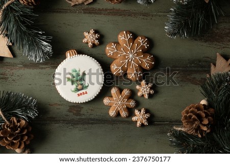 Gingerbread with a picture of a dragon in the form of a Christmas tree toy. High quality photo