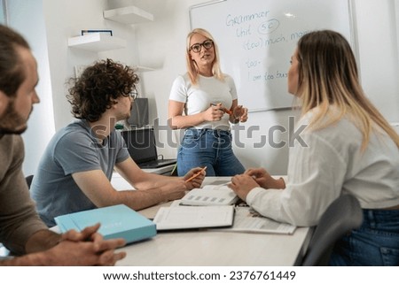 Language professor instructs students in foreign language at a diverse and vibrant language school, fostering linguistic growth and multicultural understanding.
 Royalty-Free Stock Photo #2376761449