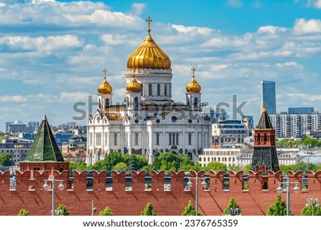 Wall and towers of Moscow Kremlin with Cathedral of Christ the Savior (Khram Khrista Spasitelya) at background, Russia Royalty-Free Stock Photo #2376765359
