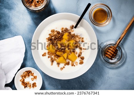 Homemade yogurt with granola and mango