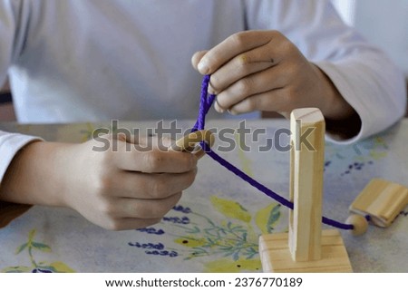 Child's hands trying to solve a brain game.