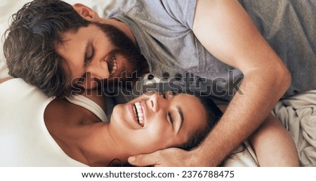 Life is gorgeous when youre in love. Shot of an affectionate young couple sharing a romantic moment in the bedroom at home. Royalty-Free Stock Photo #2376788475