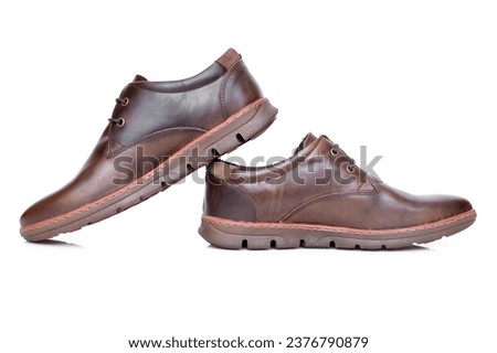 Detail of men's brown leather shoe, isolated on white background.