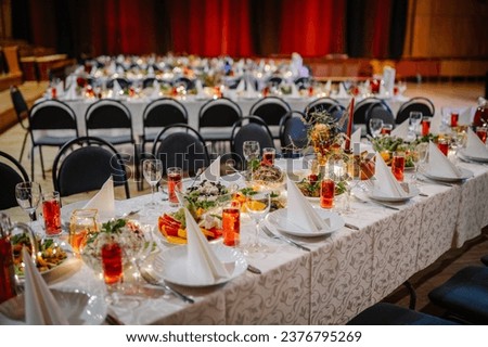 At a festive celebration, a large dinner table is set up to accommodate a considerable number of guests, ensuring a grand and communal dining experience.