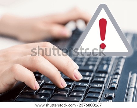 Businesswoman work on laptop with warning exclamation sign
