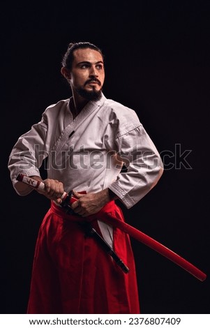 portrait of a brazilian man with samurai costume, holding his sword - Belém - Pará - Brazil Royalty-Free Stock Photo #2376807409