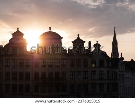 A view of building at the Grand-Place which is the central square of Brussels surrounded by gold details. Sunset hour.