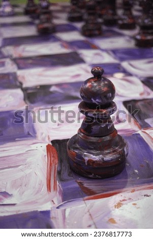 A photo of a painted, human-sized chess piece at a museum in New York City.