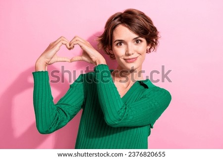 Portrait of satisfied appreciative cute woman with short hairstyle wear shirt showing heart symbol isolated on pink color background