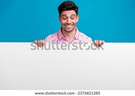 Portrait of positive person toothy smile look interested down empty space blank isolated on blue color background Royalty-Free Stock Photo #2376821285