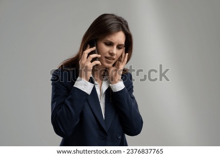 Cant hear you. Repeat please. Connection problems. Businesswoman has problems calling boss. Woman close ear when speaking phone. Busy lady talking with partners using smartphone in underground Royalty-Free Stock Photo #2376837765
