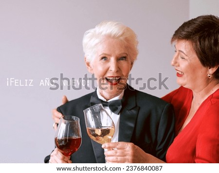 Two beautiful stylish mature senior women celebrating new year. Fun, party, style, celebration concept
