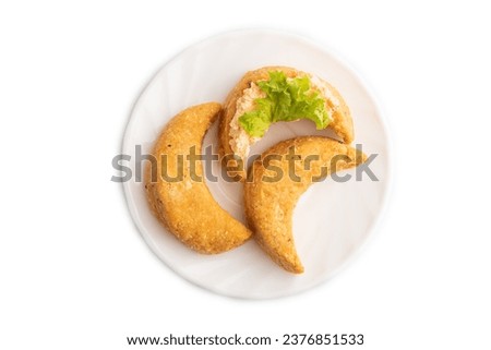 Homemade salted crescent-shaped cheese cookies isolated on white background. top view, flat lay.