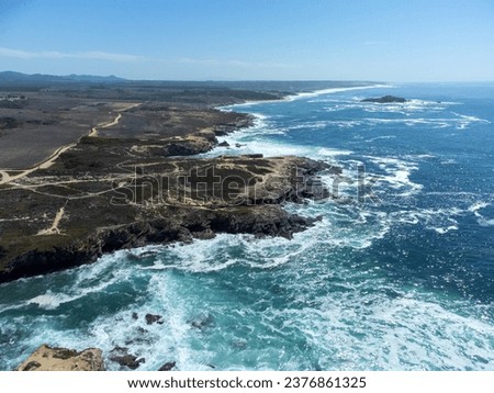 A beautiful landscape of water and cliffs against the blue sky with bright sunlight in Costa Alentejana, Alentejo, Portugal Royalty-Free Stock Photo #2376861325
