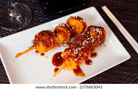 Chicken meatballs (Tsukune) traditionally served with sweetened thick yakitori tare. Japanese cuisine Royalty-Free Stock Photo #2376863043