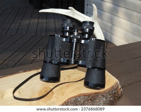 Old vintage black binoculars isolated close-up