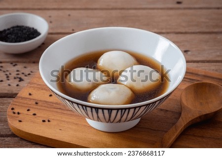 Glutinous rice balls filled with black sesame in sweet ginger soup Royalty-Free Stock Photo #2376868117