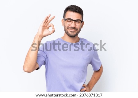 Young caucasian man isolated on white background showing ok sign with fingers Royalty-Free Stock Photo #2376871817