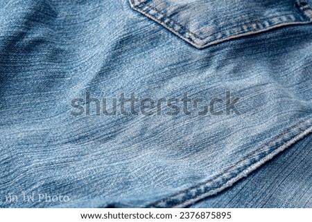 Jeans Fabric Pattern Background: Jeans Background Image Creating a background picture with a fabric pattern for jeans can add a unique and stylish touch to your design. Here's how you can describe the Royalty-Free Stock Photo #2376875895