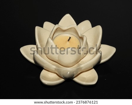 White lotus black lotus candle holder tea light candle beige decoration isolated close-up Royalty-Free Stock Photo #2376876121