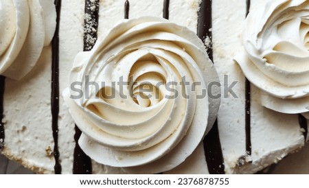 White roses made of cream on the cake. Beautiful dessert flowers. High quality stock photo.