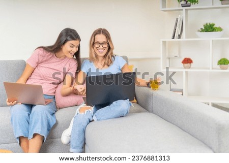 Frontal photo of friends studying using laptop together at home