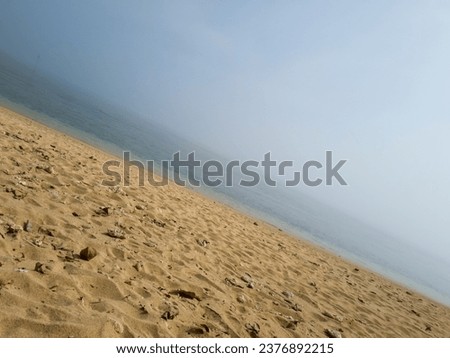 The view of the sea plus the blue sky, sand, shady trees and hills is very beautiful