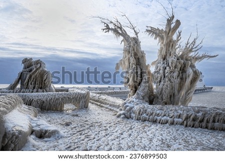 Strange Ice Formations on Pier in Lake Erie, Canada, Day after Winter Storm, stormy sky Royalty-Free Stock Photo #2376899503