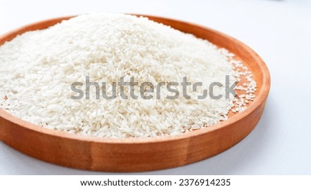 photo of white rice on wooden tray, isolated on white background.