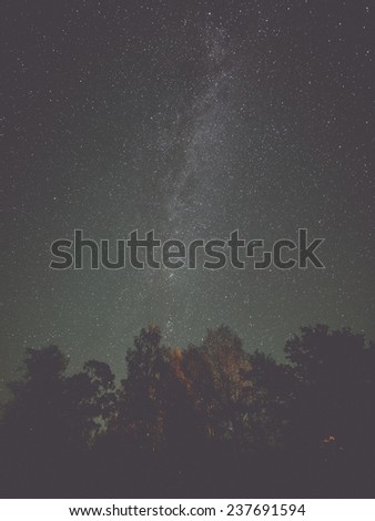 The Milky Way and some trees. Latvia - retro, vintage style look