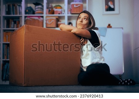 
Confused Wondering Woman Receiving a Box Boxed from a Delivery Service. Puzzled customer waiting to discover internet purchased order 
