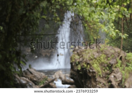 view of a waterfall in the middle of the forest with a blurred background, one of the Kemumu waterfalls in northern Bengkulu, Indonesia