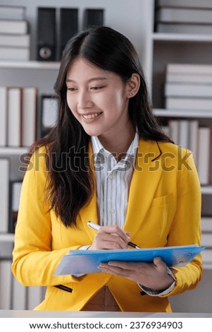 Portrait of an Asian young business Female working on a laptop computer in her workstation.Business people employee freelance online report marketing e-commerce telemarketing concept.