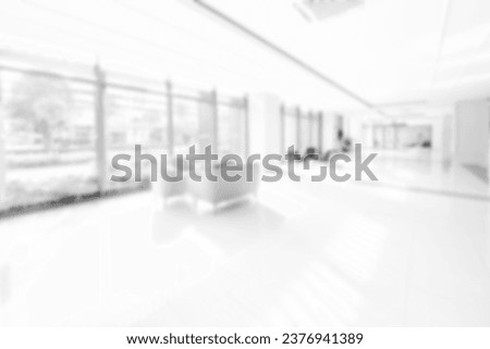 Blur background with glass door inside building gray tone. interior lobby room at sofa in hotel. Royalty-Free Stock Photo #2376941389