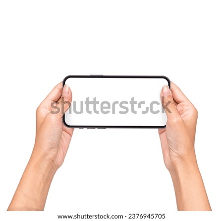 Close up of horizontal black smartphone with blank screen mockup in woman hands. Playing Game holding with two hands.