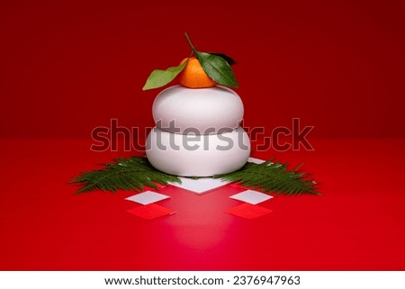 "Kagamimochi" is an offering to God.
Kagamimochi" placed in the center of the red background.
There is no base. A ceramic Kagamimochi. Royalty-Free Stock Photo #2376947963