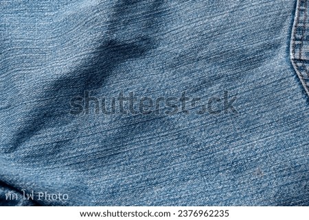 Jeans Fabric PattBackground: Jeans Background Image Creating a background picture with a fabric pattern for jeans can add a unique and stylish touch to your design. Here's how you can describe the Royalty-Free Stock Photo #2376962235