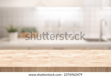 Selective focus.End grain wood counter,table top on blur kitchen counter in morning background.For montage product display or design key visual Royalty-Free Stock Photo #2376962479