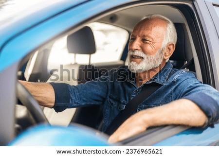 Happy man feeling comfortable sitting on driver seat in his new car. Smiling mature businessman with seat belt on driving vehicle for transport and copy space.