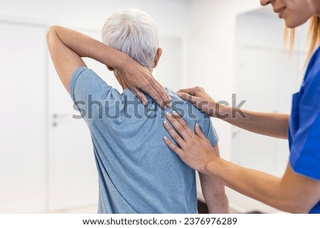 Physiotherapist doing healing treatment on womans back. Back pain patient, treatment, Doctor consulting with patient Back problems Physical therapy concept Royalty-Free Stock Photo #2376976289