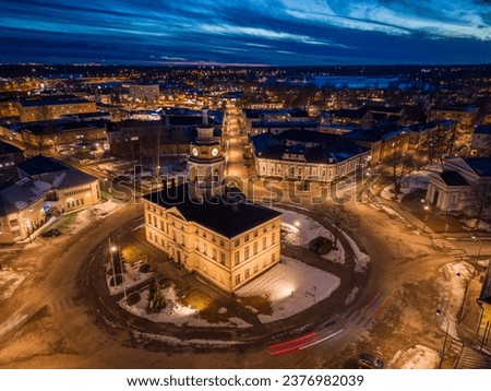 An aerial view of a cityscape in Hamina, Finland, featuring a church illuminated by the street lights Royalty-Free Stock Photo #2376982039